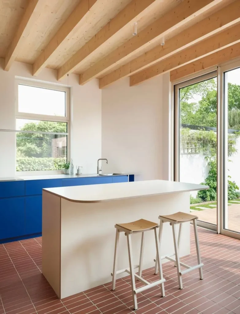 16 Kitchen Color Combination Ideas That Feel Right at Home 5 Bright cobalt blue and white kitchen with terracotta floor tiles