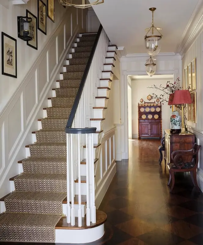 Colonial Interior Design Style: American vs. British (33 Real-Home Ideas) 7 Formal American Colonial staircase hall with raised-panel wainscoting, patterned runner, and harlequin wood floor