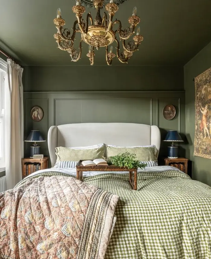 Victorian Style Bedroom: 30 Ideas for Romance Without the Heaviness 11 Victorian style bedroom with sage green panelled walls, gilt brass chandelier, antique portraits, and gingham bedding