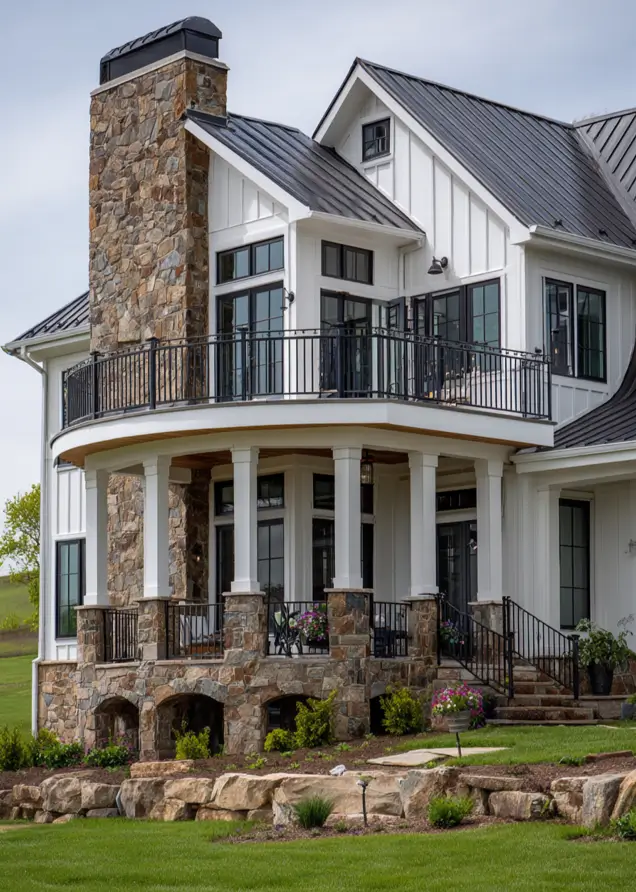 White Farmhouse with Stone Exterior: 29 Ideas That Feel Warm, Not Cold 14 Hillside farmhouse with arched stone foundation bays, stone piers, and a curved balcony