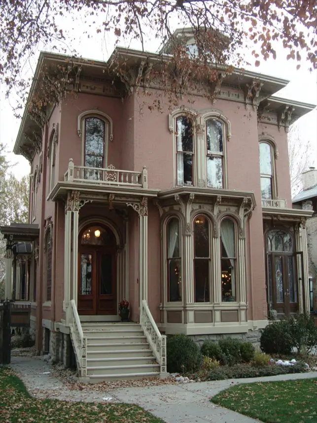Italianate Style House: 33 Ideas and the Details That Give One Away 15 Italianate style house in dusty pink brick with cream trim, a two-story bay and a small rooftop cupola