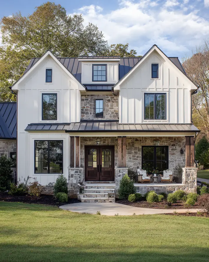 White Farmhouse with Stone Exterior: 29 Ideas That Feel Warm, Not Cold 19 Recessed stone porch between twin white gables on a farmhouse with a bronze metal roof