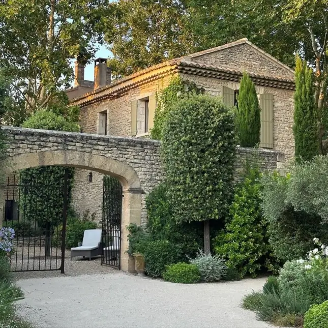 French Country House Style: An Architect's Guide to the Exterior Look 4 Provençal French Country house with rough golden stone walls, sage shutters, and a terracotta tile roof