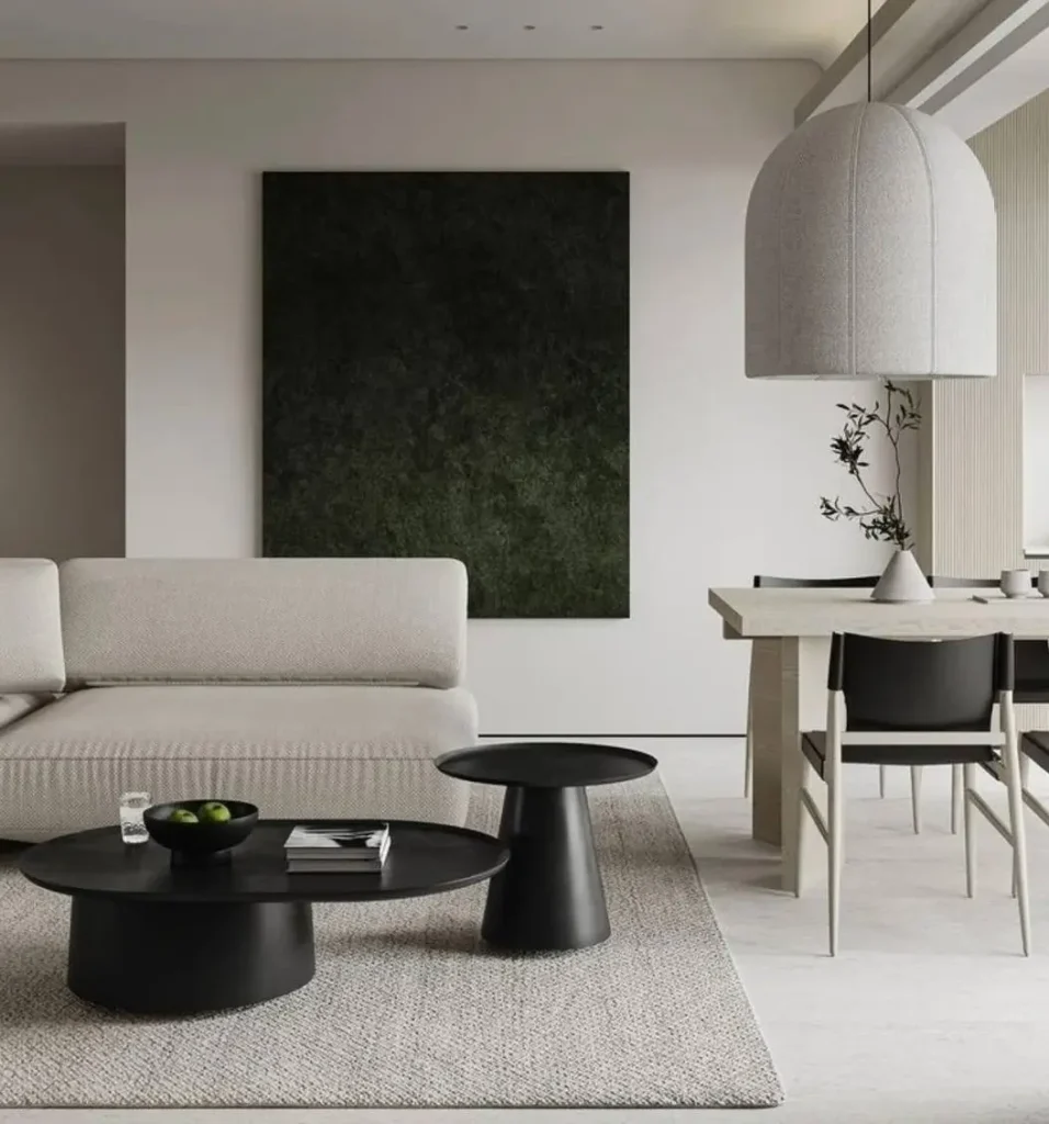 Japandi Style Living Room: Where Japanese Calm Meets Scandinavian Warmth 4 Japandi living room with a low linen sofa, black round coffee tables, and warm oak dining table