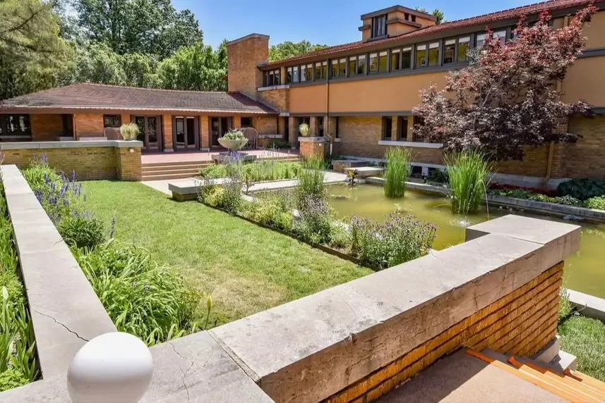 Prairie House Style: Key Features, History, and What Makes These Homes So Timeless 4 Brick garden walls and reflecting pool below the ribbon windows of a Prairie style house