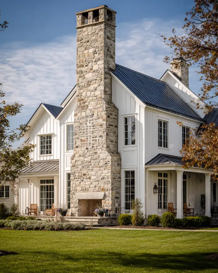 White Farmhouse with Stone Exterior: 29 Ideas That Feel Warm, Not Cold 4 Stone farmhouse chimney with a built-in outdoor patio fireplace and rocking chair seating