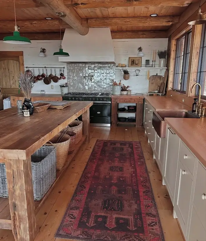 Farmhouse Kitchen Design Ideas: 36 Ways to Get the Look 22 Rustic log cabin farmhouse kitchen with a reclaimed wood island, woven basket storage, and hammered copper sink