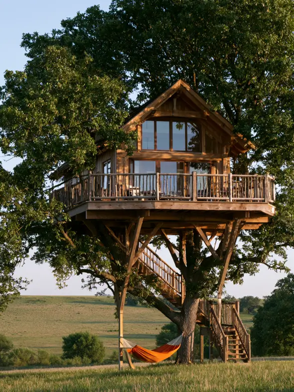 55 Treehouse Design Ideas, From Backyard Platforms to Canopy Cabins 24 Treehouse design ideas with a timber cabin, wraparound branch-railed deck and a hammock hung beneath the platform