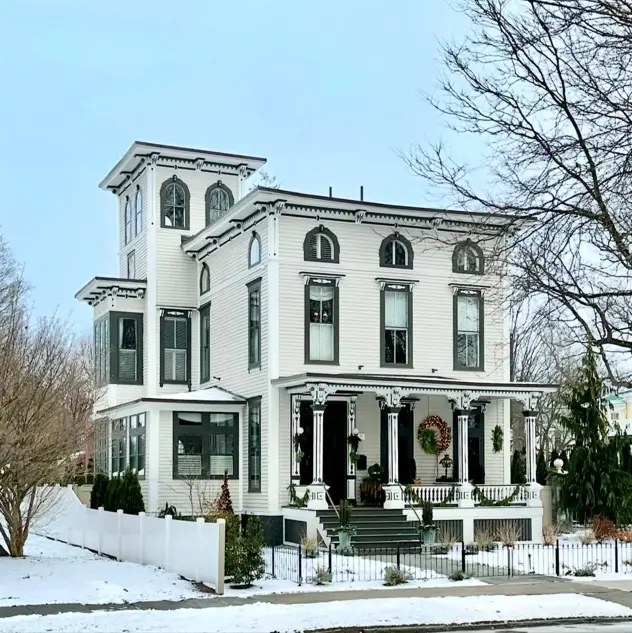 Italianate Style House: 33 Ideas and the Details That Give One Away 27 L-plan Italianate style house in white clapboard with a tower at the inner angle and arched attic windows