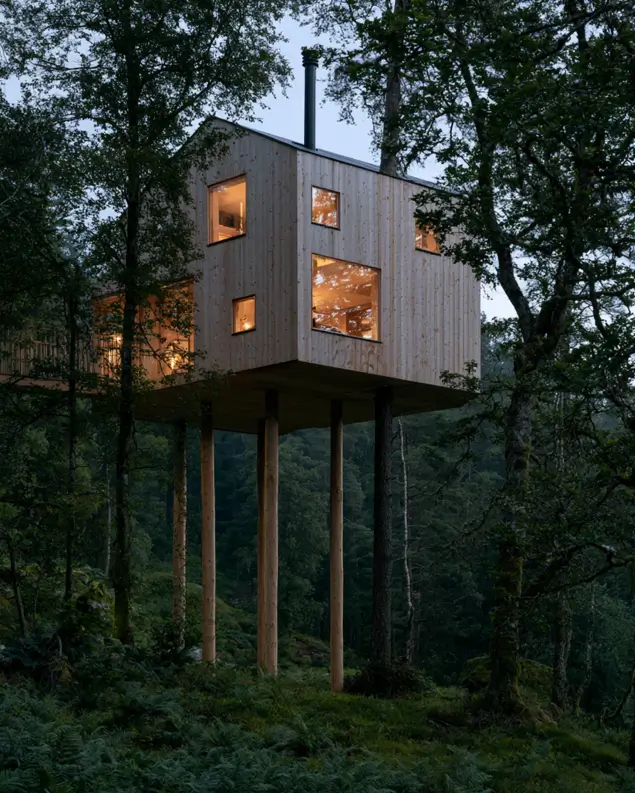 55 Treehouse Design Ideas, From Backyard Platforms to Canopy Cabins 30 Treehouse design ideas without a tree, with a pale timber box raised on four slender posts above woodland
