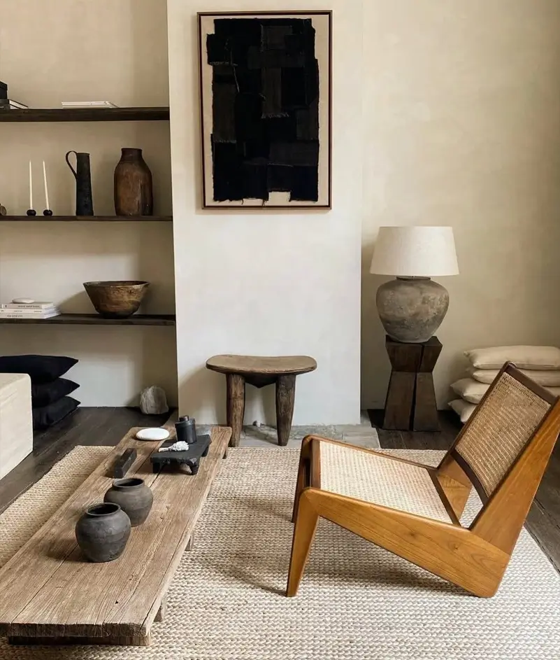 Japandi Style Living Room: Where Japanese Calm Meets Scandinavian Warmth 5 Wabi-sabi Japandi living room with a cane lounge chair, reclaimed wood table, and handmade pottery