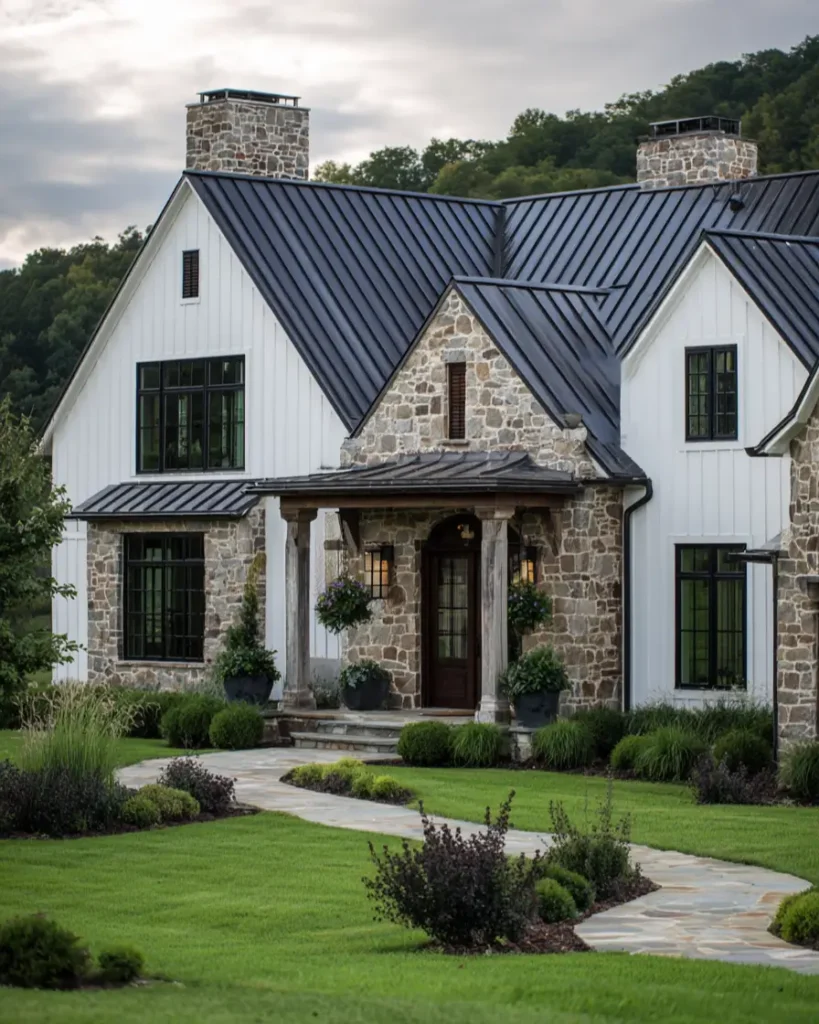 White Farmhouse with Stone Exterior: 29 Ideas That Feel Warm, Not Cold 5 White farmhouse entry gable with matching stone chimneys and rough stone porch columns