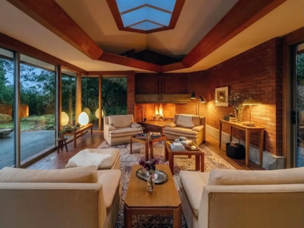 Prairie House Style: Key Features, History, and What Makes These Homes So Timeless 33 Mid-century evolution of Prairie style interior with corner brick fireplace, glass walls, and skylight
