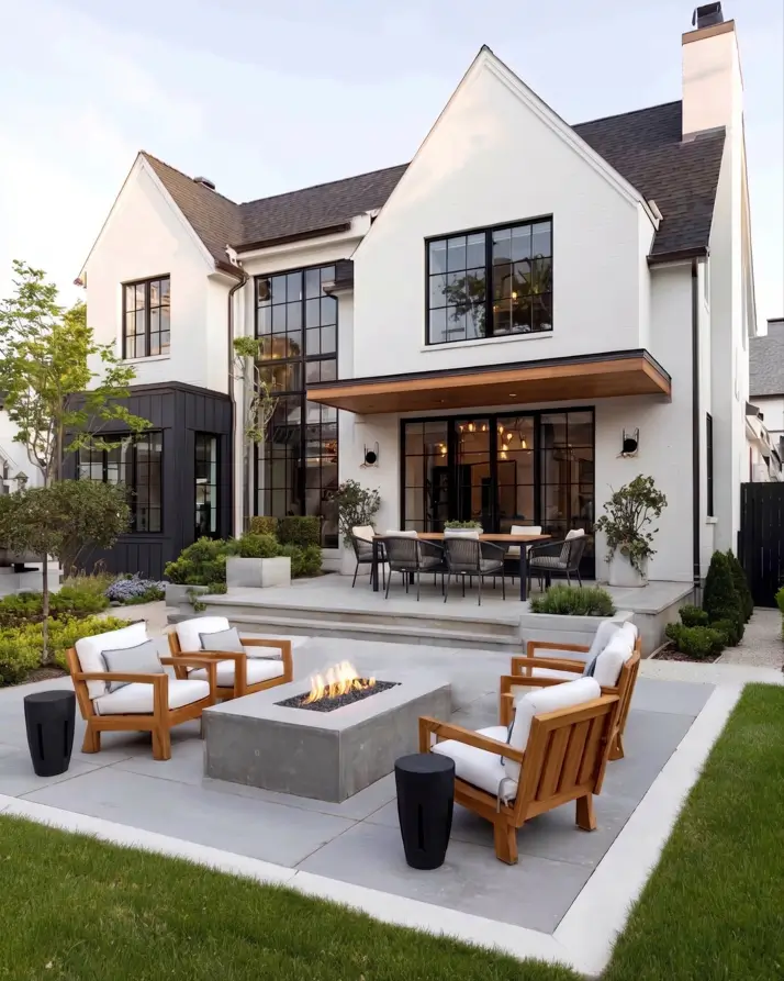 47 White Houses With Black Trim and Wood Accents We Love 39 Floating teak-lined canopy over black patio doors on a white brick modern Tudor
