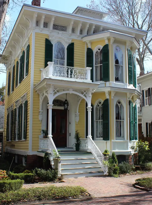 Italianate Style House: 33 Ideas and the Details That Give One Away 6 Italianate style house in yellow clapboard with pierced frieze panels, arch-topped windows and green shutters