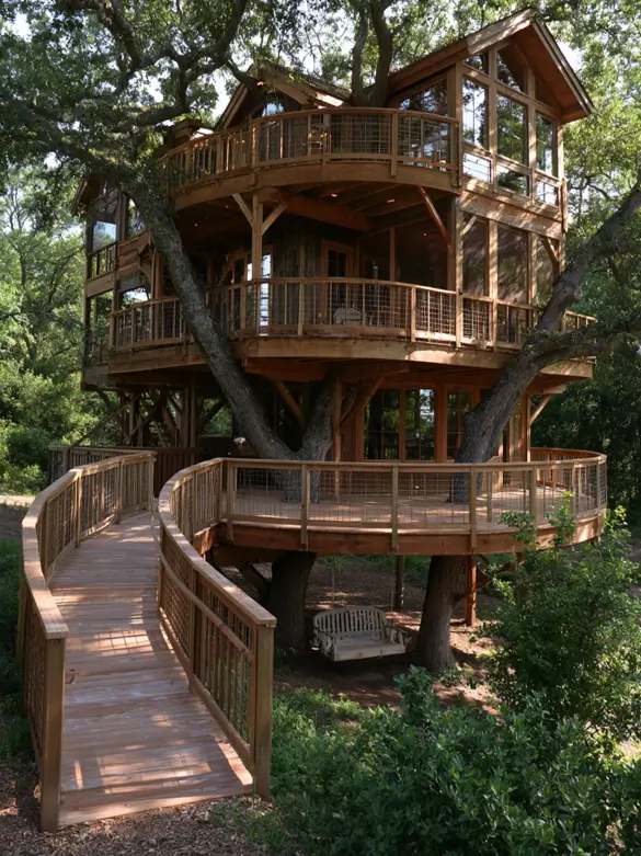 55 Treehouse Design Ideas, From Backyard Platforms to Canopy Cabins 44 Treehouse design ideas with three round timber decks around live oak limbs and a curved boardwalk ramp entry