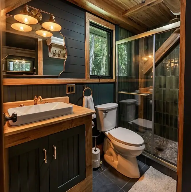 55 Treehouse Design Ideas, From Backyard Platforms to Canopy Cabins 55 Small treehouse ideas showing a compact bathroom with green tiled shower, dark panelling and a window framing a trunk