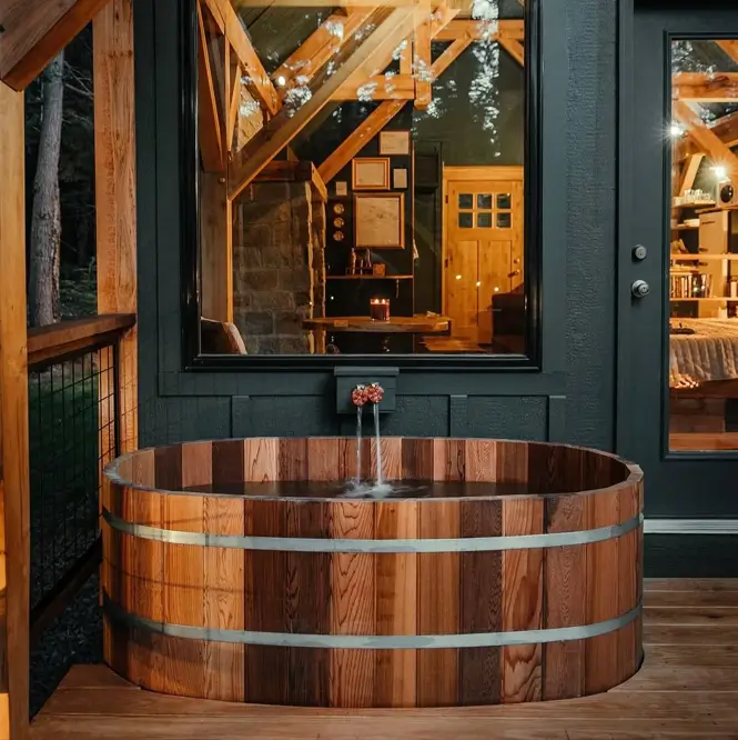 55 Treehouse Design Ideas, From Backyard Platforms to Canopy Cabins 56 Treehouse design ideas with a cedar hot tub filling on a timber deck beside dark board and batten walls