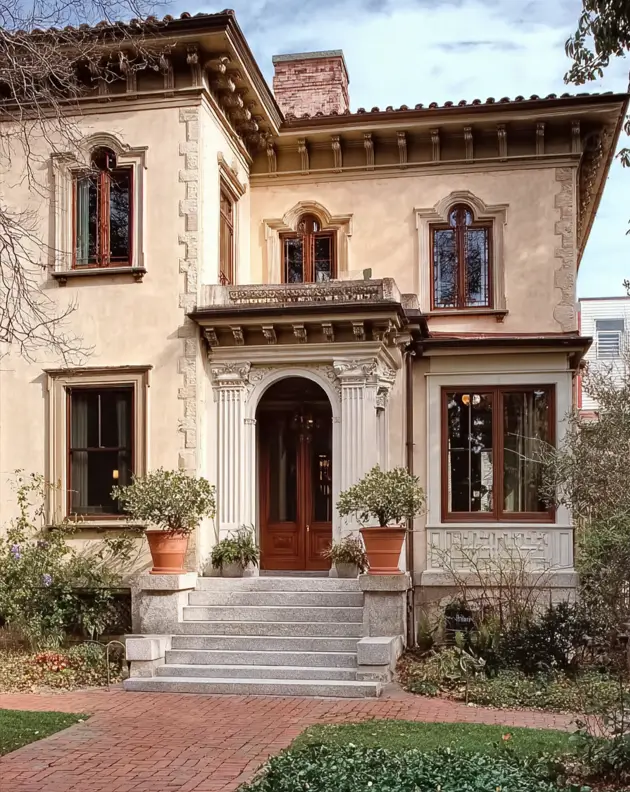 Italianate Style House: 33 Ideas and the Details That Give One Away 9 Carved acanthus brackets on a cream stucco Italianate style house with stone quoins and a fluted entry porch