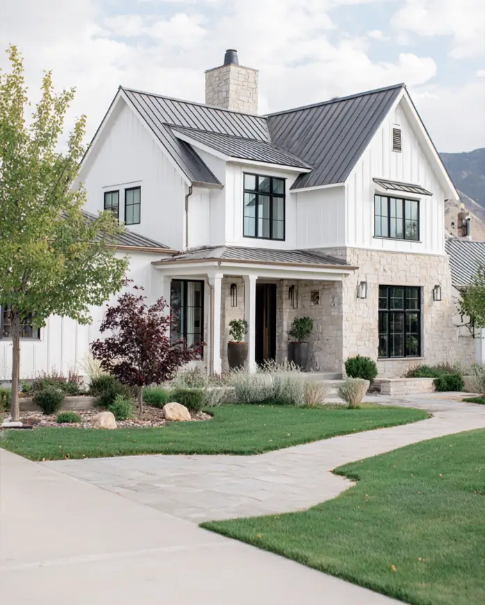 White Farmhouse with Stone Exterior: 29 Ideas That Feel Warm, Not Cold 10 Modern farmhouse with stone exterior limestone entry corner, black metal roof, and black window frames