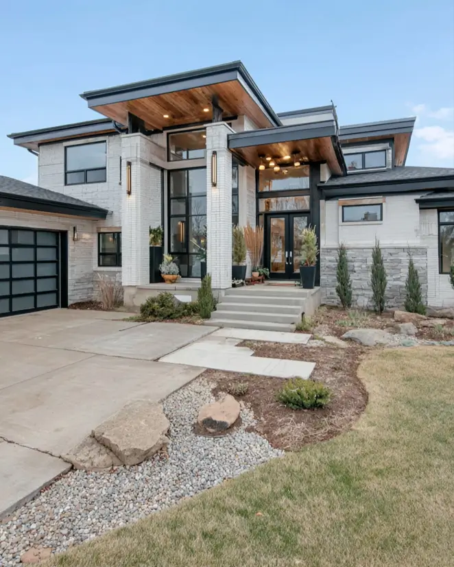 Prairie House Style: Key Features, History, and What Makes These Homes So Timeless 10 Modern Prairie style house exterior with layered rooflines, wood soffits, and stacked stone
