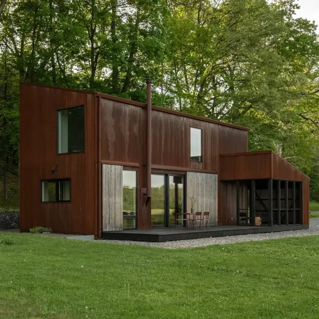 37 Brown House with Black Trim Ideas for a Warm, Modern Exterior 3 Brown house with black trim in weathered rust-brown steel with charcoal window frames and a dark deck
