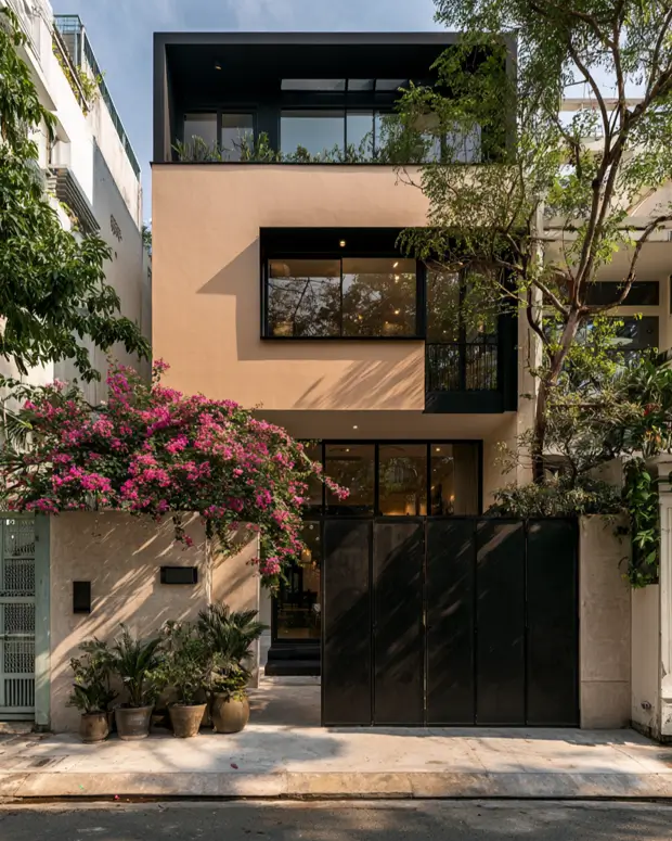 40 Tan House With Black Trim Exteriors Worth Copying 3 Tan house with black trim on a modern townhouse, with black steel window frames, a dark gate, and tan stucco