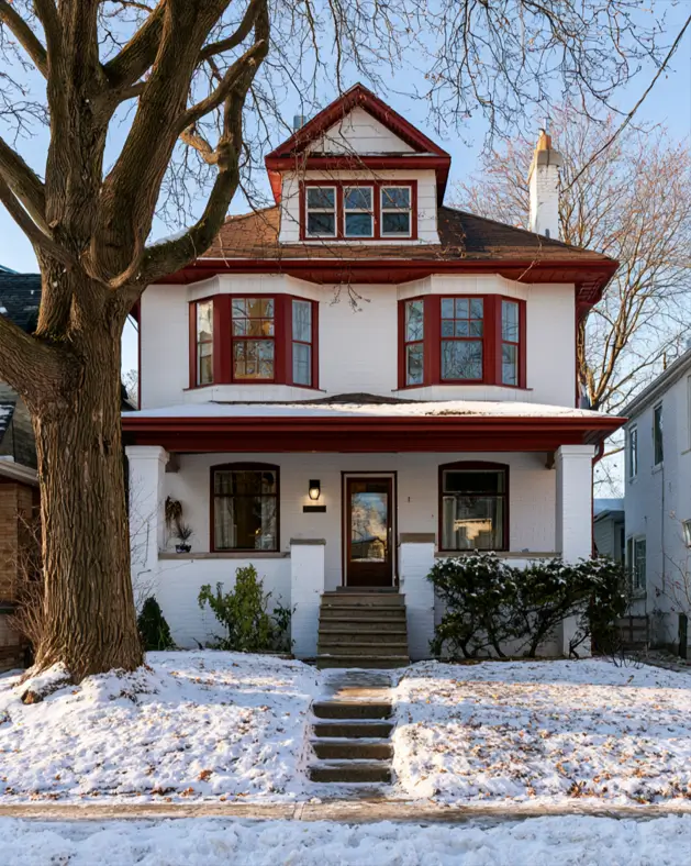White House with Red Trim: 27 Ideas and How to Pick Your Red 3 White house with red trim, deep oxblood window trim on a white-painted brick Foursquare in winter