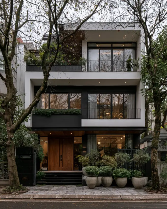46 Modern Black and White House Exterior Ideas for a Timeless Look 14 Three-story townhouse with white floor bands and black recessed panels