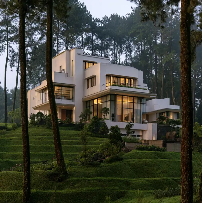 Hillside House Design: 38 Ideas for Building With the Slope 14 white modern hillside house stepping down a terraced forest slope with black-framed glass