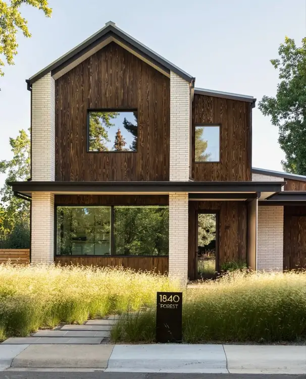 37 Brown House with Black Trim Ideas for a Warm, Modern Exterior 15 Dark brown house with black trim, charred wood siding with black-framed windows between pale brick columns