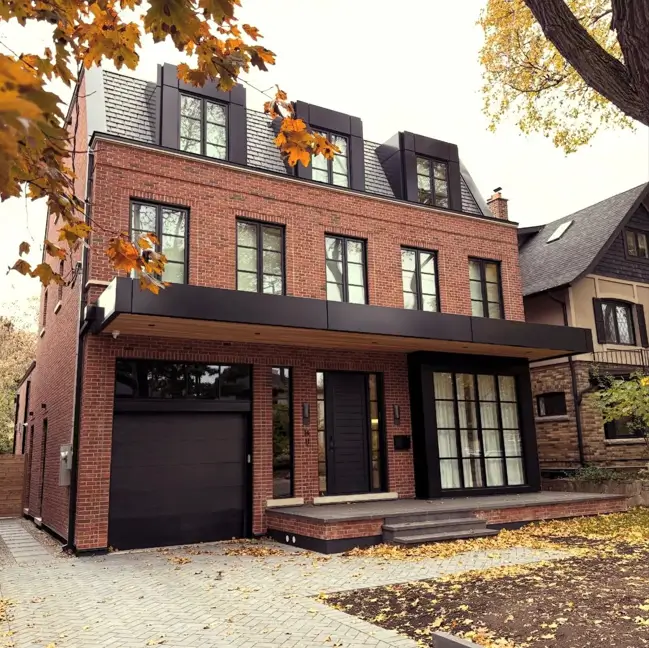 46 Red Brick House With Black Trim Ideas for Standout Curb Appeal 18 Modern red brick house with black trim, black dormers, and a black garage door