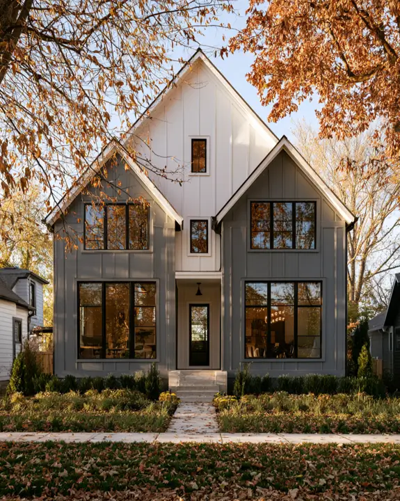 Modern Grey and White House Exterior: 30 Two-Tone Ideas 21 Modern grey and white house exterior modern farmhouse with grey board-and-batten siding, white entry bay, black windows, and steep gables
