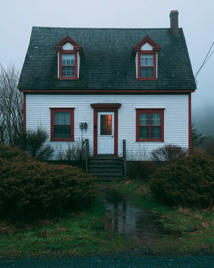 White House with Red Trim: 27 Ideas and How to Pick Your Red 21 White maritime saltbox cottage with cranberry-red window, dormer, and door trim in coastal fog