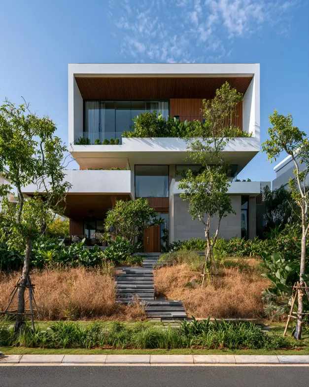 Hillside House Design: 38 Ideas for Building With the Slope 24 white cantilevered modern hillside house above a terraced tropical garden with a climbing stone stair