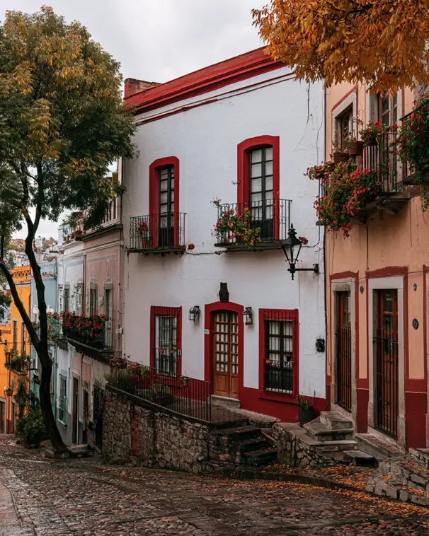 White House with Red Trim: 27 Ideas and How to Pick Your Red 24 White colonial townhouse with bold red window surrounds and geranium balconies on a cobblestone street