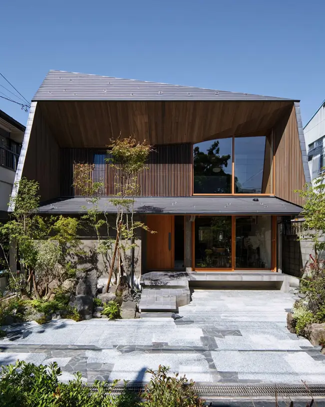 Modern Japanese House Design: 58 Ideas, Costs, and What Defines the Style 25 A wide folded metal roof with a cedar-lined soffit above timber slat screens and a stone forecourt.