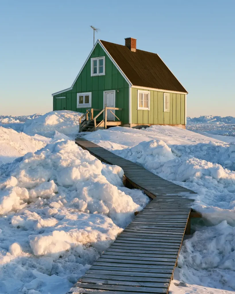 43 Green House With White Trim Ideas for Fresh Curb Appeal 28 two-tone green house with white trim and a white door on a small Greenlandic house surrounded by sea ice