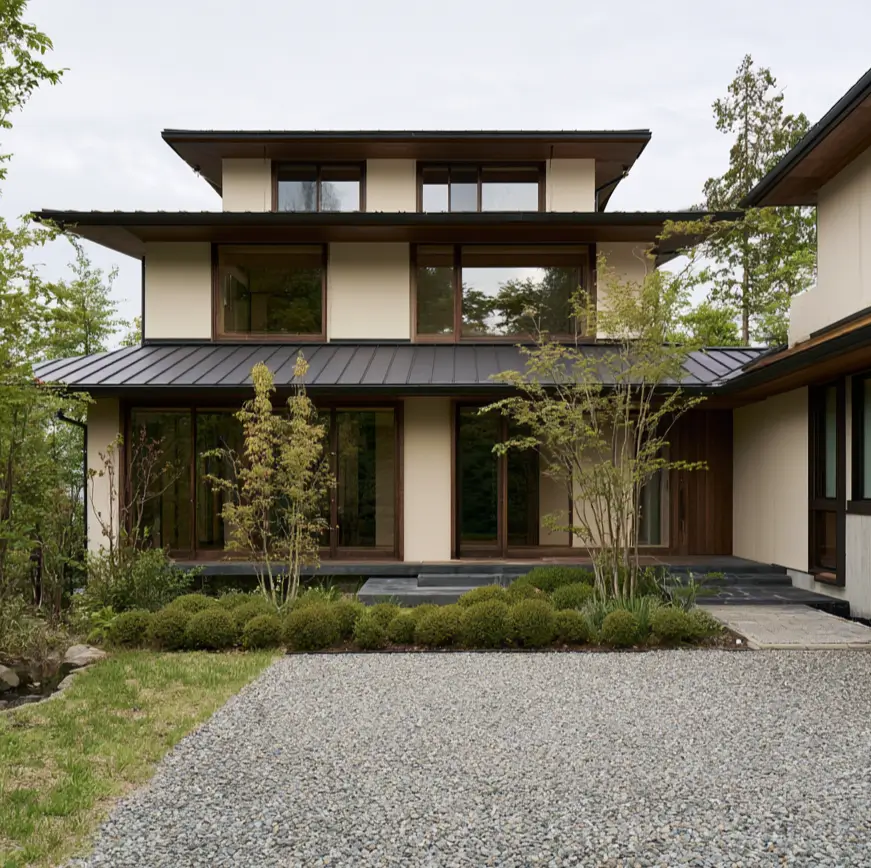 Modern Japanese House Design: 58 Ideas, Costs, and What Defines the Style 28 A modern Japanese house with three stacked projecting eaves above cream render walls.
