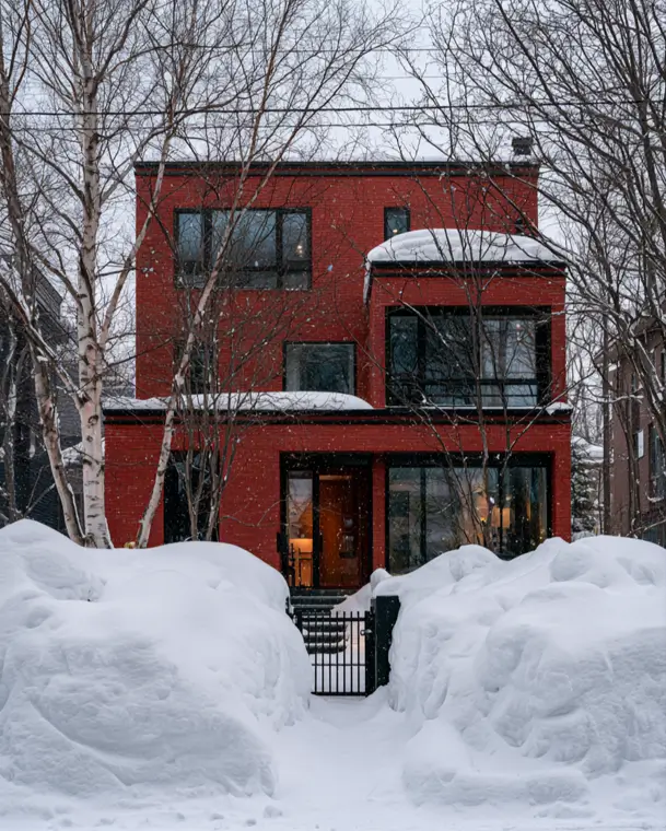 46 Red Brick House With Black Trim Ideas for Standout Curb Appeal 5 Modern red brick house with black trim and bold black-framed windows in snow