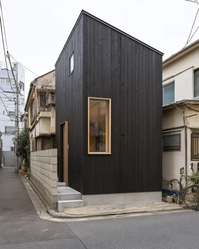 Modern Japanese House Design: 58 Ideas, Costs, and What Defines the Style 34 Charred cedar cladding built right to the plot boundary between older neighbouring buildings.