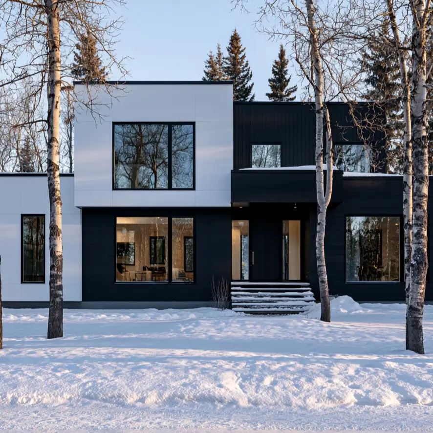 46 Modern Black and White House Exterior Ideas for a Timeless Look 34 White paneled block beside a black board and batten wing in snow