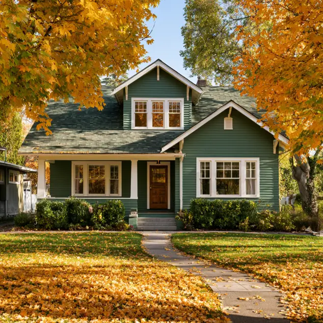 43 Green House With White Trim Ideas for Fresh Curb Appeal 35 dark green house with white trim, shed dormer, and golden maple leaves on a craftsman bungalow in fall