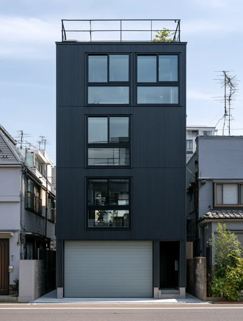 Modern Japanese House Design: 58 Ideas, Costs, and What Defines the Style 37 A four-storey small modern Japanese house in dark ribbed metal with a rooftop garden.