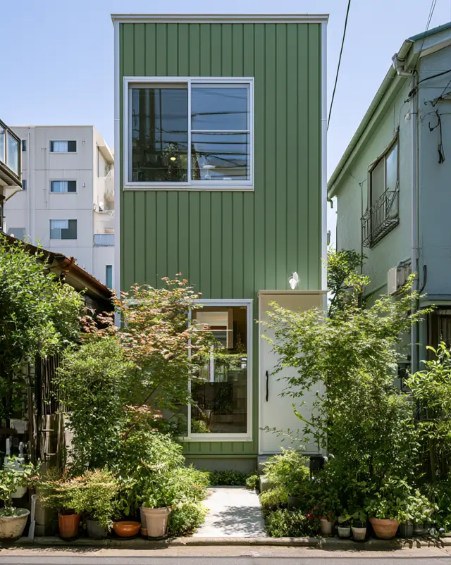 43 Green House With White Trim Ideas for Fresh Curb Appeal 6 sage green house with white trim, gridded window frames, and a white balcony railing on a minimalist modern home