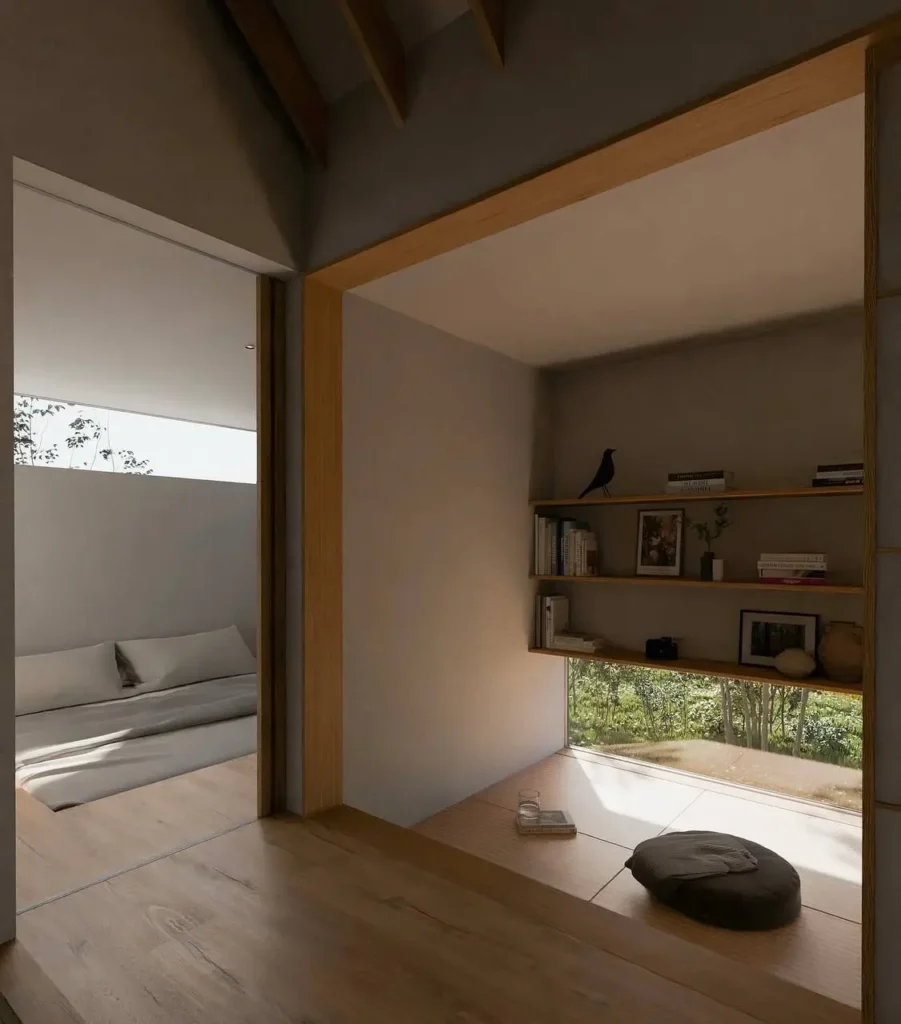 Modern Japanese House Design: 58 Ideas, Costs, and What Defines the Style 56 A modern Japanese house interior with a raised tatami nook, floor-level window, and open oak shelves off a plank-floored room.