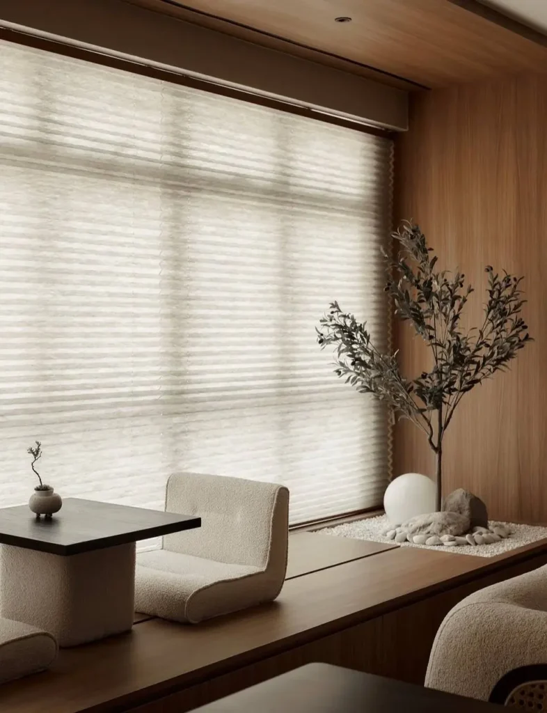 Modern Japanese House Design: 58 Ideas, Costs, and What Defines the Style 60 A modern Japanese house window seat area with a low timber platform, boucle seating, and a gravel-and-stone strip along the sill.
