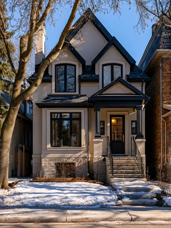 Taupe House With Black Trim: 28 Ideas + Best Paint Colors 10 Taupe house with black trim on a warm taupe stucco home with black gable bargeboards and a stone base