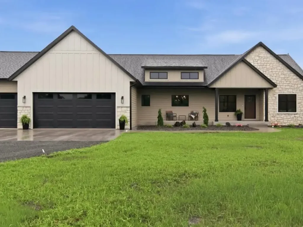 40 Tan House With Black Trim Exteriors Worth Copying 93 Tan house with black trim on a modern farmhouse ranch, with black garage doors, stone accents, and a covered porch