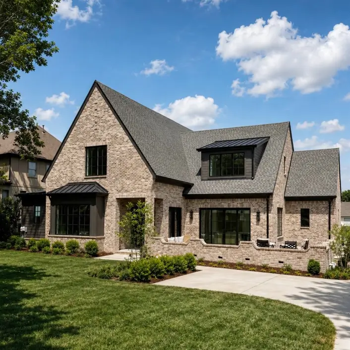 Blonde Brick House Ideas: 24 Warm Exteriors That Still Feel Fresh 4 Modern blonde brick house with black window frames, a black metal roof accent, and grey mortar over a steep gable